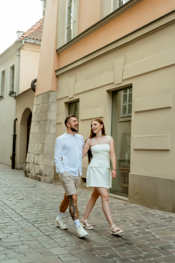 Photoshoot of a couple in the old town of Krakow. A guy and a girl are walking along the narrow streets