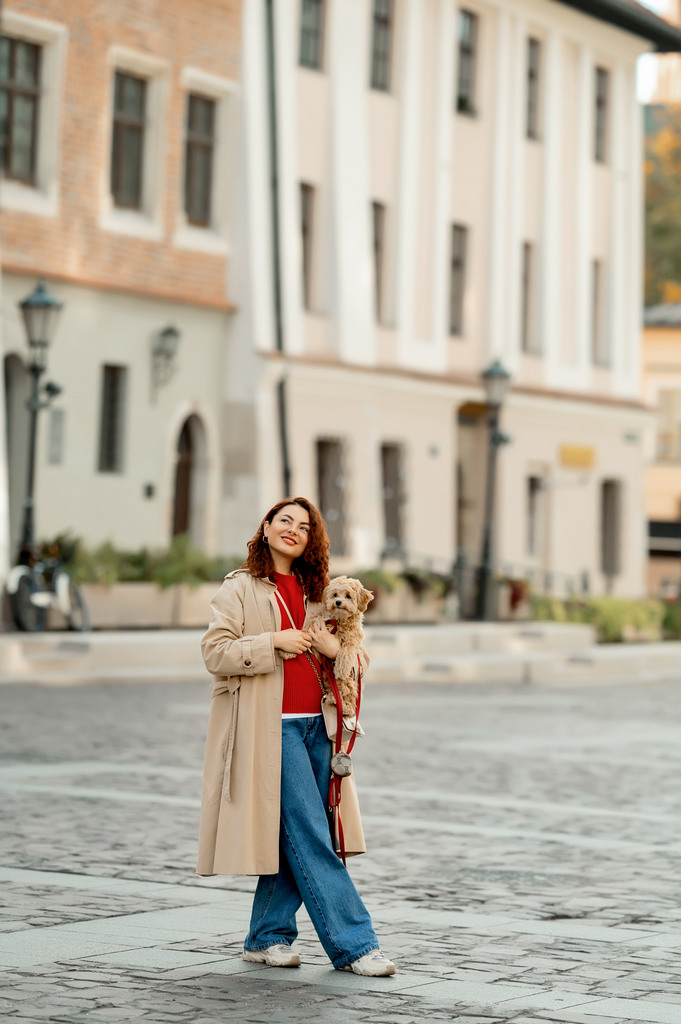 Photoshoot of a girl in the old town of Krakow. A girl walks with a dog