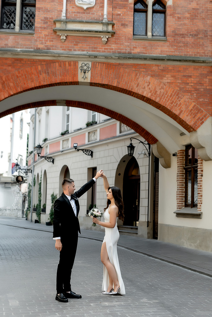 Photoshoot of a wedding girl in the old town of Krakow. A girl walks along the streets of the old town in the spring